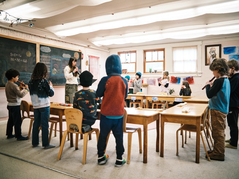 Children playing recorders together in a Waldorf classroom